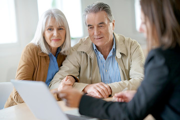 Advisor meeting with senior couple at their home